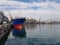 Cargo ship during unloading and loading in an industrial port, in the background loading cranes. Commercial port, Delivery