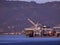 Cargo Shipping boat is unloaded by cranes in Oakland Harbor on a foggy day