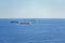 Cargo ships Freighters anchored at Mediterranean Sea and sailboats sailing