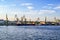 Cargo ships and harbor cranes in the Kherson river port - view from the Dnieper river Ukraine. Water surface against the