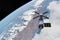 Cargo space craft Earth planet.Dark background. Sci-fi wallpaper.Space Station Orbiting Earth.Space ship.Space art wallpaper.Solar