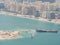 Cargo tanker and various construction equipment build an artificial island in Dubai.