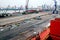 Cargo terminal for unloading steel plates from bulk carrier by ships cranes. View of the pier, cranes and various equipment. Port