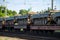 Cargo train carrying military tanks on railway flat wagons