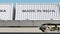 Cargo train and containers with MADE IN INDIA caption. Railway transportation. 3D rendering