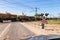 Cargo train riding over a railway crossing