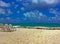 Caribbean beach with chairs and surf gliding