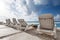 Caribbean beach with sunbathing beds