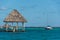Caribbean scene with hut and Sailboat. Bacalar, near tulum. Trav