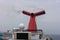 The Caribbean Sea - May 26, 2020: Funnel and main open deck screen of Carnival Valor anchored at sea in the fog. Grey foggy sky