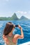 Caribbean travel girl taking photo with phone on St Lucia Pitons boat cruise ride in tropical vacation summer lifestyle