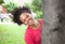 Caribbean woman behind a tree