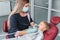 Caries treatment procedure in stomatology clinic close-up. Dentist in uniform holding dental tools. Young boy sitting in the chair