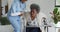 Caring african american female doctor helping senior african american female