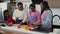 Caring african mom teaching teenage girls cooking