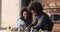 Caring African mother play wooden blocks with little daughter