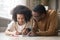 Caring black dad drawing with colored pencils teaching child girl