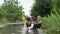 Caring for brother, cute loving child caring for his little one and takes off rubber boots to pour water while playing