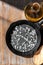 Caring for cast iron cookware. Cast iron pan salt oil and wooden spatula on the table. Kitchen utensils for cooking and