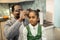 Caring cheerful father fixing hair slide on hair of his daughter