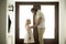 Caring dad dressing buttoning little daughter at home, good fath