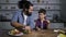 Caring dad and son making delicious fruit kebabs