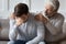 Caring elderly father comfort upset adult son