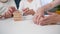 Caring for elderly, female social worker playing board game with old man and woman and standing tower of wooden blocks