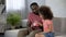 Caring father teaching child to save money, girl putting coins into piggy bank