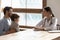 Caring female doctor talk with little patient at hospital consultation