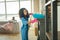 Caring female medical attendant dusting the fireplace