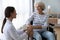 Caring female nurse support disabled elder woman patient on wheelchair