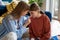 Caring foster mother connects with teenage daughter share secrets while sitting on floor at home.