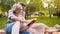 Caring guy reading story to his beautiful lady, gently hugging her, date in park