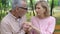 Caring husband holding hands of old sick wife, alzheimer disease, family support