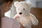 Caring little kid examine plush teddy bear