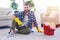 Caring male in gloves having rest while brushing carpet