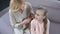 Caring mature mother combing daughter blond hair, beauty time, relationship