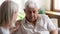 Caring mature woman comfort support upset elderly man