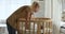 Caring mom put sleeping baby to cozy wooden round crib