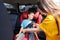 Caring mother checking seat belt sleeping son