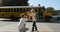 Caring mother escorting son to school bus. Mom watch child boarding schoolbus.