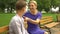 Caring mother spending time with her teenage son, straighten collar of his shirt