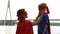 Caring mother in superhero costume looking with love at son, proud of her child