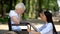 Caring nurse calming crying disabled senior woman in wheelchair, slow recovery