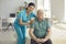 Caring nurse hugs old man patient smiling looking at camera during visit at home