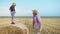 Caring parent, father having fun with his son jumping from a haystack