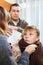 Caring parents giving medicinal sirup to son