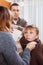 Caring parents giving medicinal sirup to teenage boy