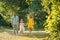 Caring parents holding hands of daughter while walking together